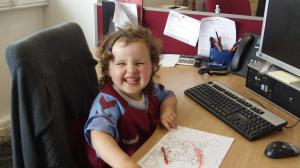 Nik and Brian's eldest finds the real action at Villa Park: coloring at mommy's desk
